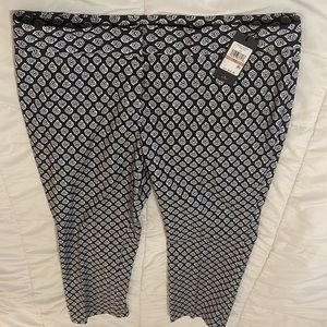 Floral print pants with zipper front, tapered leg, lightweight cotton fabric.